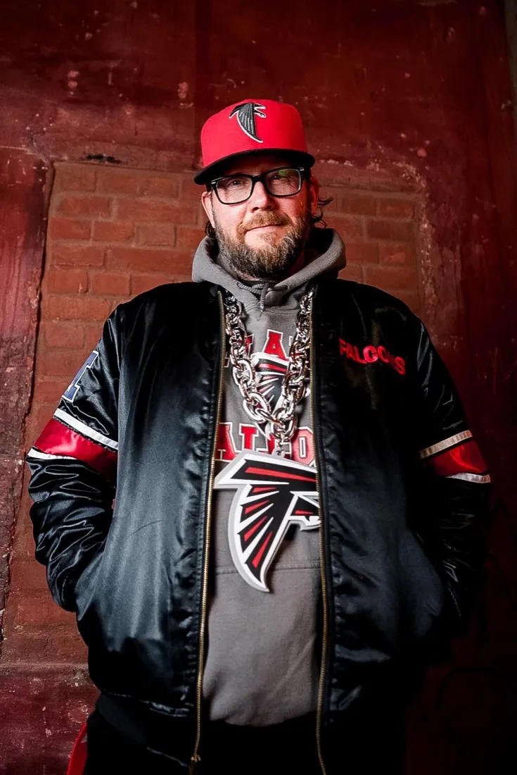 Finished media-day portrait of a Falcons fan with chain and cap